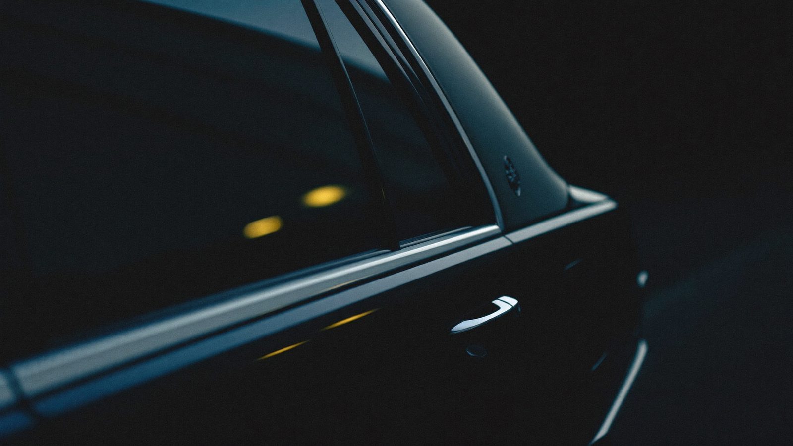 Black limousine at night — detail